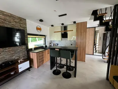 a kitchen with a table and a television in it at Domek Stróski in Wola Stróska