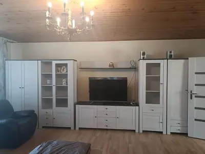a living room with a television and white cabinets at apartament blisko Energylandii in Zator