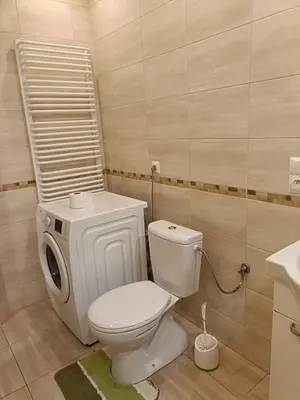 a bathroom with a white toilet and a shelf at apartament blisko Energylandii in Zator