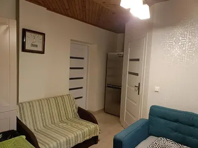 a living room with a couch and a chair at apartament blisko Energylandii in Zator