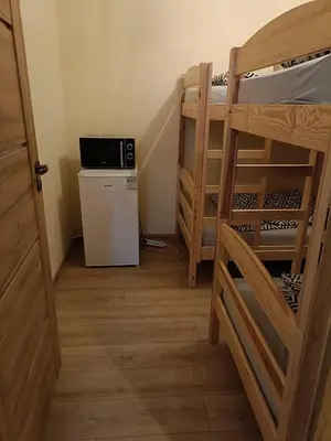 a small room with a refrigerator and bunk beds at apartament blisko Energylandii in Zator