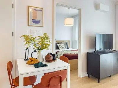 a room with a table and a bedroom with a bed at Klimeckiego Luxury Apartments 215 in Kraków