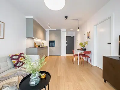 a living room with a couch and a table at Klimeckiego Luxury Apartments 215 in Kraków