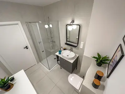 an overhead view of a bathroom with a sink and shower at Klimeckiego Luxury Apartments 215 in Kraków