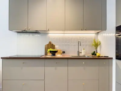 a kitchen with white cabinets and a sink at Klimeckiego Luxury Apartments 215 in Kraków
