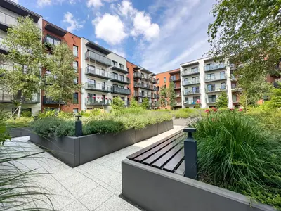a park bench in front of some apartment buildings at Klimeckiego Luxury Apartments 215 in Kraków