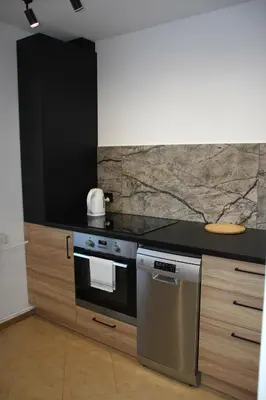 a kitchen with a stove and a counter top at Apartment Jerzmanowskiego Krakow in Kraków