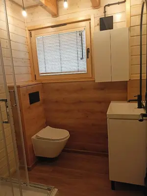 a bathroom with a toilet and a sink and a window at Winnica Zatorska in Olszyny