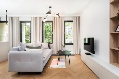 a living room with a couch and a tv at Comfort Corner in Kraków - by Upstairs in Kraków