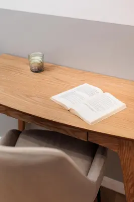 an open book on a wooden table with a candle at Comfort Corner in Kraków - by Upstairs in Kraków