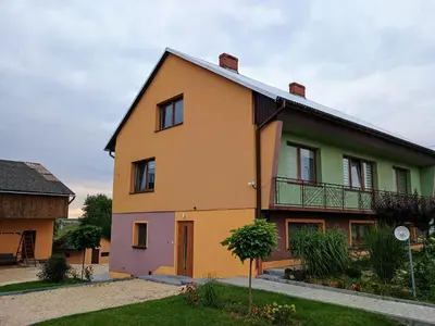 a house that is painted yellow and green at Studio nad S-ką in Brzuchania