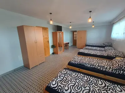 a bedroom with two beds and a desk in it at Studio nad S-ką in Brzuchania