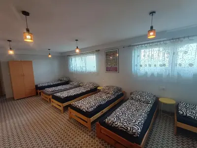 a group of four beds in a room at Studio nad S-ką in Brzuchania