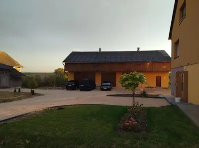 a building with cars parked in a parking lot at Studio nad S-ką in Brzuchania