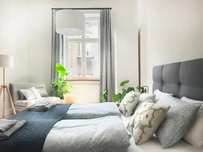 a bedroom with a large bed and a window at Beautiful Apartment for 8 people in Cracow's heart in Kraków