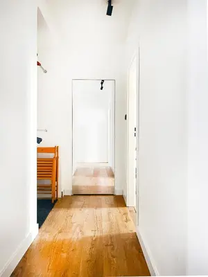 an empty hallway with white walls and wooden floors at Beautiful Apartment for 8 people in Cracow's heart in Kraków