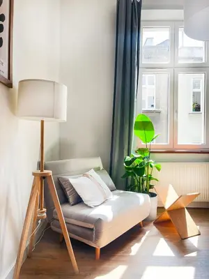 a living room with a couch and a lamp at Beautiful Apartment for 8 people in Cracow's heart in Kraków
