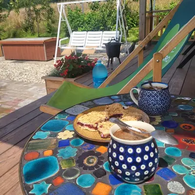 a table with a plate of food and a cup of coffee at Domek drewniany z sauną in Bieńkówka