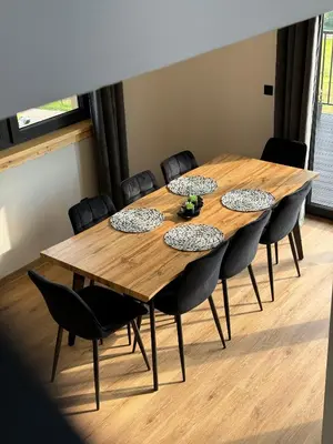 a conference room with a wooden table and chairs at Domek DE-Luxe BUFLAK in Nowy Targ