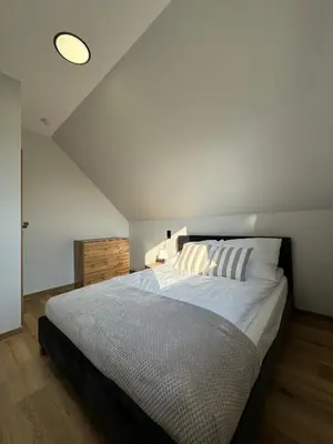 a bedroom with a large bed in a room at Domek DE-Luxe BUFLAK in Nowy Targ