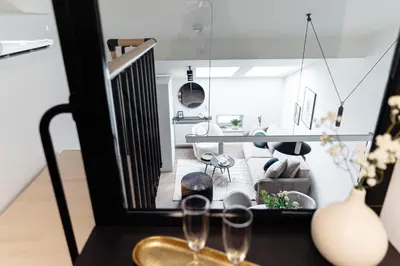 a living room with two wine glasses on a table at Miodova20 by StayLab in Kraków