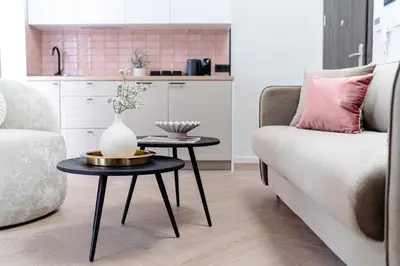 a living room with a couch and a table with a vase on it at Miodova20 by StayLab in Kraków