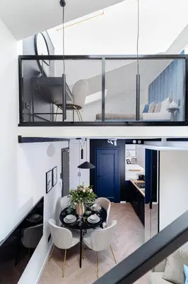 a living room with a dining table and chairs at Miodova20 by StayLab in Kraków