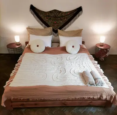 a bedroom with a large bed with two end tables at ChilLoud - apartament na Kazimierzu in Kraków