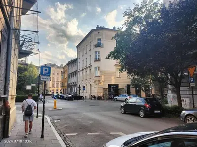 a man walking down a street in a city at ChilLoud - apartament na Kazimierzu in Kraków