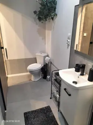 a small bathroom with a toilet and a sink at ChilLoud - apartament na Kazimierzu in Kraków