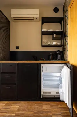 a kitchen with an open refrigerator and cabinets at Różana Loft - Old Town in Kraków