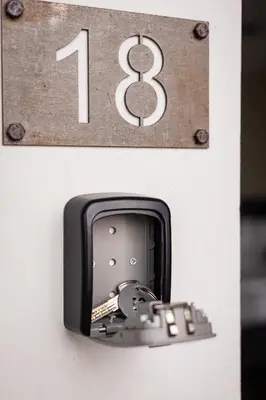 a black and whiteangular object with a number and a key at Różana Loft - Old Town in Kraków