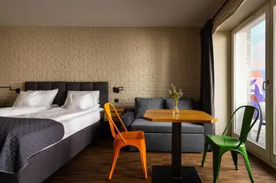 a bedroom with a bed and a table and chairs at Różana Loft - Old Town in Kraków