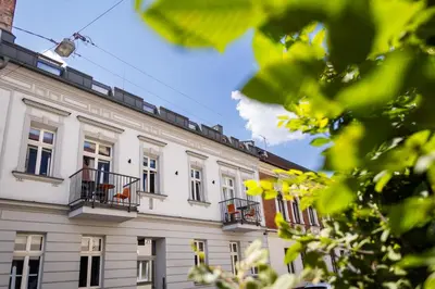a white building with windows and balconies at Różana Loft - Old Town in Kraków