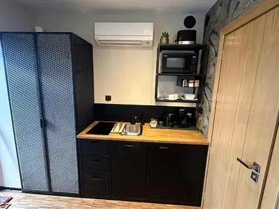 a small kitchen with a stove and a counter top at Różana Loft - Old Town in Kraków