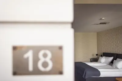 a bedroom with a bed with the number at Różana Loft - Old Town in Kraków