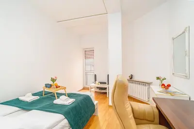 a living room with a table and a couch at Penthouse in the Center - by Hosty in Kraków