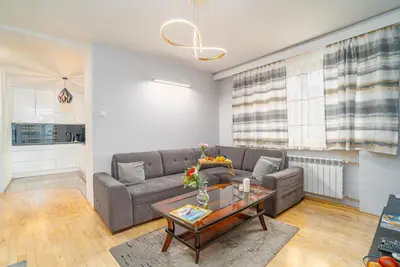 a living room with a couch and a table at Penthouse in the Center - by Hosty in Kraków