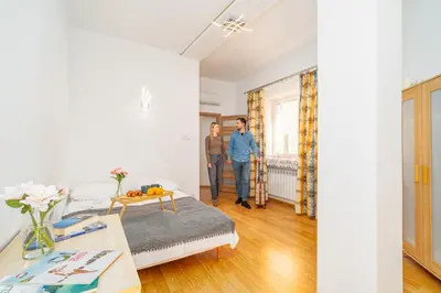 two men are standing in a living room at Penthouse in the Center - by Hosty in Kraków