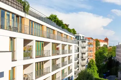 an apartment building with colorful balconies in a city at Fragola Apartments Wawel View Zwierzyniecka in Kraków