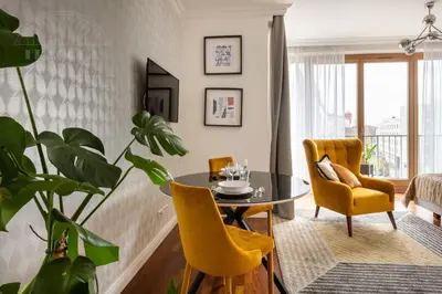 a dining room with a table and chairs and a tv at Fragola Apartments Wawel View Zwierzyniecka in Kraków