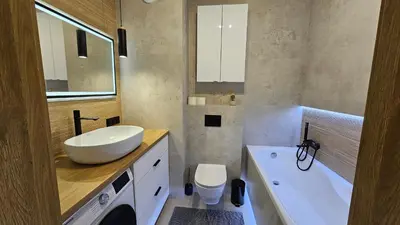 a bathroom with a sink and a toilet and a tub at Apartament Zdunów in Kraków