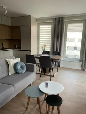 a living room with a couch and a table at Apartament Zdunów in Kraków