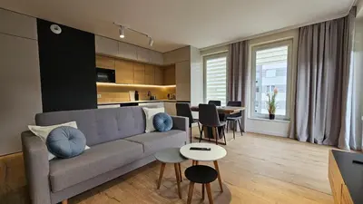 a living room with a couch and a table at Apartament Zdunów in Kraków