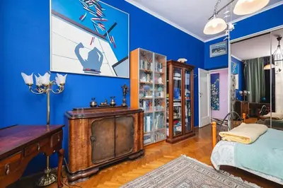 a blue room with a bed and a desk at Fine Art Luxury Apartment 110 m2 , 3 min walk to Main Square in Kraków
