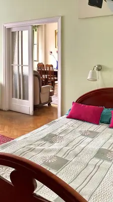 a bedroom with a bed and a living room at Fine Art Luxury Apartment 110 m2 , 3 min walk to Main Square in Kraków