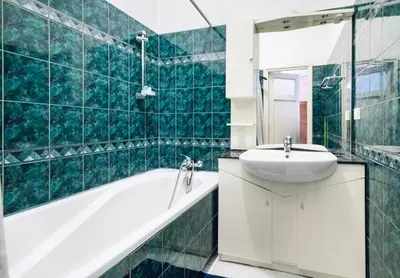 a green tiled bathroom with a sink and a tub at Fine Art Luxury Apartment 110 m2 , 3 min walk to Main Square in Kraków
