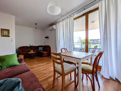 a living room with a table and chairs and a couch at Dworska 1B by Homeprime in Kraków