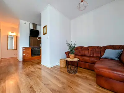 a living room with a brown leather couch at Dworska 1B by Homeprime in Kraków