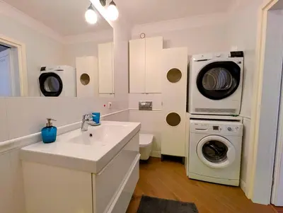 a bathroom with a washing machine and a sink at Dworska 1B by Homeprime in Kraków